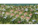Aerial view of waterfront homes on a sunny day with mature landscaping, private drives, and luxury finishes at 2910 Hardy Ave, New Smyrna Beach, FL 32168