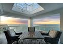 Inviting outdoor seating area with fire pit table on a private balcony overlooking the ocean at 3000 N Atlantic Ave # 24, Daytona Beach, FL 32118