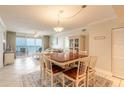 Well-lit dining area with seating for six and ocean views through a sliding glass door at 3315 S Atlantic Ave # 1106, Daytona Beach, FL 32118