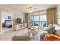 Inviting living room with tile floors, comfortable seating, and a balcony with ocean views at 3315 S Atlantic Ave # 1106, Daytona Beach, FL 32118