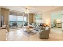 Relaxing living room featuring a large sliding glass door leading to a balcony and ocean views at 3315 S Atlantic Ave # 1106, Daytona Beach, FL 32118