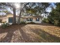Inviting single-story home featuring a one-car garage, classic shutters, and large trees at 370 Charles Ave, Orange City, FL 32763