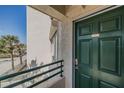 Close up of the front door and railing with ocean view and palm trees in the background at 4631 S Atlantic S Ave # 8201, Ponce Inlet, FL 32127