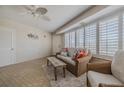 Bright living room with tile flooring, fan, shutters and comfortable seating at 4631 S Atlantic S Ave # 8201, Ponce Inlet, FL 32127