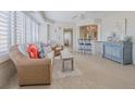 Cozy living room with tile flooring and open to the kitchen with bar stool seating at 4631 S Atlantic S Ave # 8201, Ponce Inlet, FL 32127
