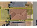 Aerial view of a house with brown roof shingles, surrounded by well-kept lawns and neighboring properties at 5065 Nw 35Th Pl, Ocala, FL 34482