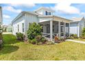 Charming light blue single-story home with a cozy front porch and well-maintained lawn on a sunny day at 562 Landshark Blvd, Daytona Beach, FL 32124