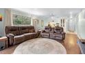 Living room boasts hardwood floors, a large window, and comfortable seating at 600 N Boundary Ave # 115D, Deland, FL 32720