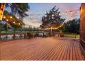 Spacious wooden deck with string lights, offering a relaxing outdoor space for gatherings at 725 E New York Ave, Orange City, FL 32763