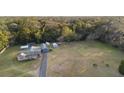 Expansive aerial view of a single-story home with a long driveway, detached garage, and lush green surroundings at 753 Glenwood Rd, Deland, FL 32720
