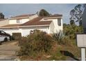 Two-story home with a large window and manicured bushes at 1101 Monticello Ln # 3, Port Orange, FL 32129