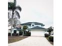 Charming two-story home featuring a brick driveway, lush landscaping, and a two-car garage at 112 Muscovy Ct, Daytona Beach, FL 32119