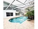 Enjoy this private screened-in pool with brick pavers, lush landscaping, and a serene backyard at 112 Muscovy Ct, Daytona Beach, FL 32119