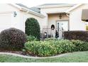 Beautiful front yard landscaping with flowering plants and manicured shrubs leading to the front door at 12841 Se 97Th Terrace Rd, Summerfield, FL 34491