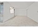 Open living room featuring tiled floors, lots of natural light and seamless flow into the kitchen at 140 Orchid Woods Ct # 7A, Deltona, FL 32725