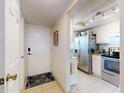 Inviting entryway with tiled floors leads to a modern kitchen featuring stainless steel appliances at 144 S Halifax Ave # 86, Daytona Beach, FL 32118
