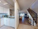Spacious living area featuring wood floors, and access to a modern kitchen and the stairs at 144 S Halifax Ave # 86, Daytona Beach, FL 32118