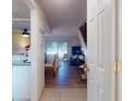 Open-concept living room visible from the kitchen with wood floors and natural light from the sliding glass doors at 144 S Halifax Ave # 86, Daytona Beach, FL 32118