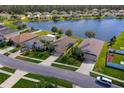 A tranquil neighborhood showcases beautiful homes along a serene lake with lush greenery at 1750 Savannah Ln, Port Orange, FL 32128