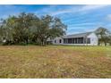 Expansive backyard with mature trees and lush green grass, perfect for outdoor entertaining at 1983 Stacey Cir, Deltona, FL 32738