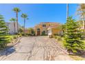 Charming two-story home with a stamped concrete driveway, mature palms and manicured landscaping at 20 Promenade At Lionspaw, Daytona Beach, FL 32124