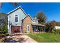 Charming two-story home with stone accents and a welcoming front porch swing at 2057 Hillview Circle, Deltona, FL 32738
