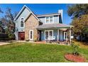 Charming two-story home with stone accents and a welcoming front porch swing at 2057 Hillview Circle, Deltona, FL 32738