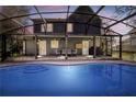 Beautiful in-ground pool with screened enclosure and outdoor seating area at 2057 Hillview Circle, Deltona, FL 32738
