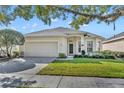 Charming single-story home with a well-manicured lawn and a two-car garage at 212 Stonington Way, Deland, FL 32724