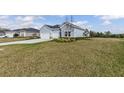 Beautiful single-story home with a three-car garage and lush green lawn at 2236 Oconnel Dr, Ormond Beach, FL 32174