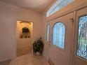 Bright entryway with decorative glass door and sidelights, a plant and niche for displaying decor at 2327 Addison Ave, Clermont, FL 34711