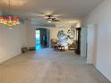 Spacious living room featuring neutral carpet and a ceiling fan at 2327 Addison Ave, Clermont, FL 34711
