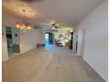 Bright living room with neutral carpet, ceiling fan and kitchen view at 2327 Addison Ave, Clermont, FL 34711