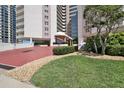 The attractive condo building offers an inviting entrance with well-manicured landscaping at 2967 S Atlantic Ave # 1203, Daytona Beach Shores, FL 32118