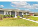 Inviting front entrance with a covered porch and decorative shrubs at 317 Oak Hill Dr, Altamonte Springs, FL 32701