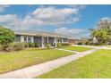 Well-maintained front yard with lush green grass and mature trees at 317 Oak Hill Dr, Altamonte Springs, FL 32701