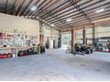 Well-lit and organized garage interior with workbench, tool storage, and plenty of space for vehicles at 4252 Quail Ranch Rd, New Smyrna Beach, FL 32168