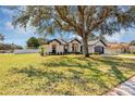 Charming single-story home with a well-manicured lawn and mature tree at 509 Kettering Rd, Deltona, FL 32725