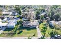 Aerial view of a single-story home with canal access in a quiet neighborhood at 55634 Sam St, Astor, FL 32102