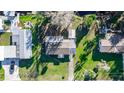 Birds eye view of a cozy home with a large yard, surrounded by lush greenery at 55634 Sam St, Astor, FL 32102