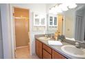 Clean bathroom with double sinks, wooden cabinets, and a tiled shower stall at 6152 Sequoia Dr, Port Orange, FL 32127