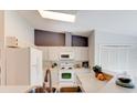 Well-lit kitchen with white appliances, neutral countertops, and ample cabinet space for storage and meal preparation at 6152 Sequoia Dr, Port Orange, FL 32127