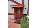 Welcoming front entrance features a decorative door with a canopy, stylish lighting, and manicured shrubs at 625 N Halifax Ave # 15, Daytona Beach, FL 32118