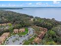 Beautiful aerial view of a lakeside community surrounded by wooded areas at 100 Sweetgum Woods Ct # 11D, Deltona, FL 32725
