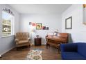 Cozy living room with hardwood floors, a comfortable chair, and a grand piano at 1318 Pup Fish Ln, Deland, FL 32724