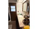 Cozy bathroom featuring a vanity with a sink and decorative mirror and fixtures at 1420 Felton St, Deltona, FL 32725