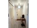 Bright hallway with neutral walls, hardwood floors, closet, and decorative lighting fixture at 1420 Felton St, Deltona, FL 32725