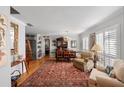 Inviting living room featuring hardwood floors, plantation shutters, and a stylish oriental rug at 1552 Covered Bridge Dr, Deland, FL 32724