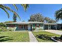 Beautiful single-story home featuring neutral green paint, decorative shutters, and an attached carport at 1590 N Page Dr, Deltona, FL 32725