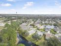 Picturesque aerial view of a residential neighborhood with pond and lush greenery at 232 Gala Cir, Daytona Beach, FL 32124